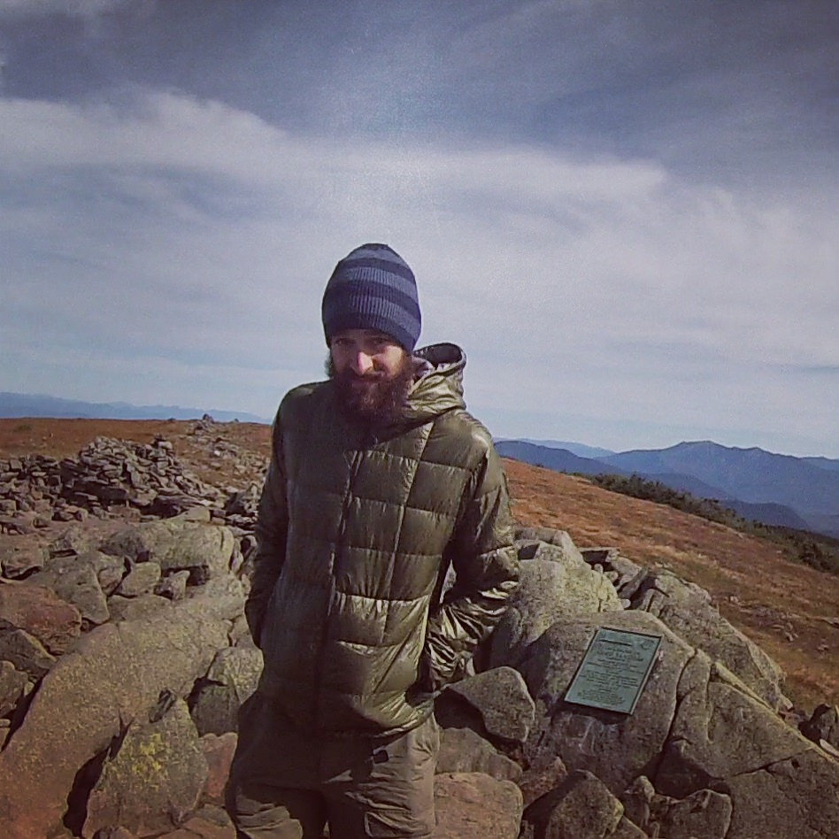 hiker in puffy jacket in windy weather