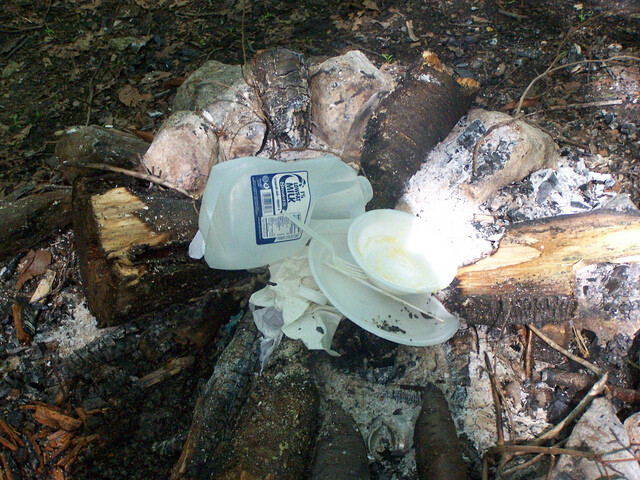 burning trash in campfire