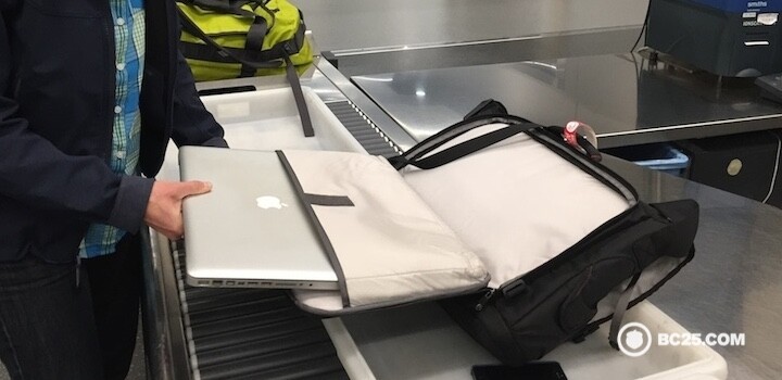 Using the FastPass system at security. The laptop sleeve is very convenient.